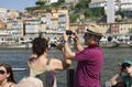Porto, Portugal, August 21, 2018: an Italian couple takes pictures from a tourist boat on the phone of a tourist attraction in