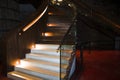 Porto, Portugal, August 21,2018: Stairs with glass fence under artificial light. The staircase is located in a dark basement