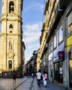 Porto, Portugal. August 12, 2017: View of the base of the clergy tower and beginning of the narrow commercial street called Asunci Royalty Free Stock Photo