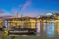 Porto Portugal, night city skyline at Ribeira and Douro River with Rabelo wine boat Royalty Free Stock Photo