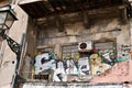 Porto, Portugal, 1.04.2017. Colorful graffiti on crumbling backyard facade close to Sao Bento railway station.