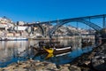 PORTO, PORTUGAL - JANUARY 18,2018: Boats carrying barrels of porto wine seen docking at river bank. Panorama View on Porto, Duoro