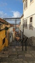 Porto, Portugal - July 5, 2023: Narrow alleyway in Porto\'s old town with view of Dom Luis I colorful traditional houses