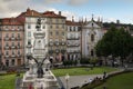 View of the beautiful Praca do Infante D. Henrique with people relaxing in the lawn, in the city of Porto