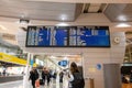 Porto, Portugal: November 13 2022. Young woman standing with her backpack looks at schedule on airport station. Themed public