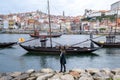 Porto, Portugal: November 13 2022. Young woman tourist looking to the boats at Douro river Royalty Free Stock Photo