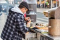 Street vendor of hot chestnuts cooked over charcoal in Porto, Portugal