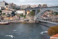 Porto, Portugal, October 31,2020. View on bridge, colorful old houses on hill in old part of city and embankment of Douro river in