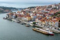 Porto, Portugal, October 31,2020. View on colorful old houses on hill in old part of city and embankment of Douro river in rainy