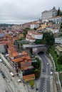 Porto, Portugal, October 31,2020. View on colorful old houses on hill in old part of city and embankment of Douro river in rainy