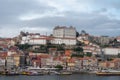 Porto, Portugal, October 31,2020. View on colorful old houses on hill in old part of city and embankment of Douro river in rainy