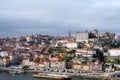 Porto, Portugal, October 31,2020. View on colorful old houses on hill in old part of city and embankment of Douro river in rainy