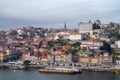 Porto, Portugal, October 31,2020. View on colorful old houses on hill in old part of city and embankment of Douro river in rainy