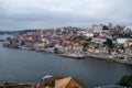 Porto, Portugal, October 31,2020. View on colorful old houses on hill in old part of city and embankment of Douro river in rainy