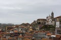 View to Porto`s downtown Portugal from the cathedral view point. Church on the top of the hill. Portuguese traditional houses