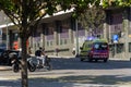 Porto, Portugal - 08/28/2019: Red and yellow ambulance responding to an emergency. Men stopped in their bikes and people walking Royalty Free Stock Photo