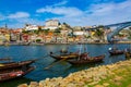 Porto, Portugal Riberia old town cityscape with Dom Lusi bridge and the Douro River with traditional Rabelo boats