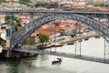 Riverboat sailing on the river Douro, with double-deck metal arch bridge