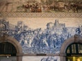 Porto, Portugal - Sao Bento train station interior with beautiful azulejos blue tiles on the wall depicting historic scenes