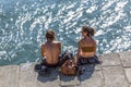 View of couple sitting on docks at the Douro river, sunbathing and enjoying the view