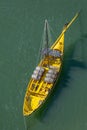 View of river Douro, with a yellow Rabelo Boat with barrels of Port wine