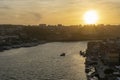 Porto, Portugal - 09/25/2019: Porto view at sunset. Douro river with boats. Ribeira e Vila Nova de Gaia