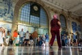 Porto, Portugal - 08/28/2019: Woman with pink hair walking. SÃÂ£o Bento train station. Crowd of people walking