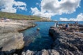 Porto Selvaggio, Puglia, Italy. August 2021. Amazing view over the bay of Porto Selvaggio, some tourists move on the rocks. In the