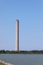 Porto Tolle, RO, Italy - July 5, 2023:Chimney of thermoelectric plant and Po River