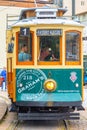 Porto, vintage Portuguese traditional city tram Infante 1 designed with advertisements with the view on the river