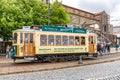 Porto, vintage Portuguese traditional city tram Infante 1 designed with advertisements with the view on the river