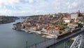 Porto yellow tram train passing on the luis 1 bridge. Panorama of the city behind