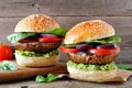 Portobello mushroom meatless burgers against a dark wood background Royalty Free Stock Photo