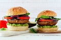 Portobello mushroom vegetarian burgers against a white wood background Royalty Free Stock Photo