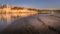 Portocolom town houses, harbour, port, golden light, sunrise, calm blue mediterranean sea, fishing boats, sandy beach, reflection Royalty Free Stock Photo