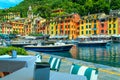 Portofino harbor with boats and cozy street cafe, Liguria, Italy