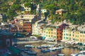 Portofino in Italy, sea and coast. Colorful buildings and tourists.