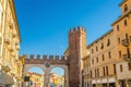 Portoni della Bra gate with merlons and clock, old Roman city double brick gate