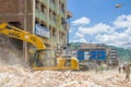 Portoviejo, Ecuador - April, 18, 2016: Heavy machinery picking rubble from destroyed buildings after tragic and