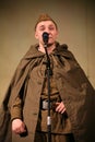 Portra Soviet soldier, hero in uniform of World War II playing the accordion over black background.