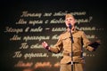 Portra Soviet soldier, poet, hero in uniform of World War II playing the accordion over black background. Royalty Free Stock Photo