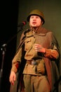 Portra Soviet soldier, poet, hero in uniform of World War II playing the accordion over black background. Royalty Free Stock Photo