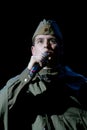 Portra Soviet soldier, poet, hero in uniform of World War II playing the accordion over black background. Royalty Free Stock Photo