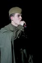 Portra Soviet soldier, poet, hero in uniform of World War II playing the accordion over black background. Royalty Free Stock Photo