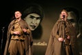 Portra Soviet soldiers, hero in uniform of World War II playing the accordion over black background.