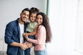 Portraif Of Happy Arabic Parents Posing With Their Little Daughter At Home Royalty Free Stock Photo