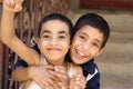 Portrait of 2 boys playing and laughing, street background in giza, egypt