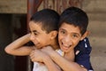 Portrait of 2 boys playing and laughing, street background in giza, egypt