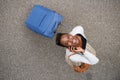 Above of happy african american woman walking with suitcase and mobile phone Royalty Free Stock Photo