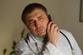 Portrait of absorbed doctor talking on his mobile phone